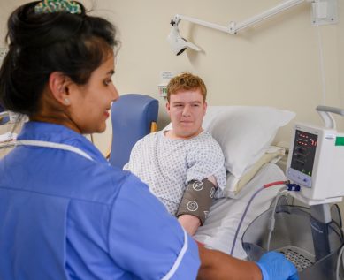 A nurse takes a patient's blood pressure