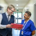 Staff in discussion over a folder