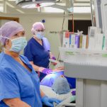 Surgeons look at a monitor in theatre