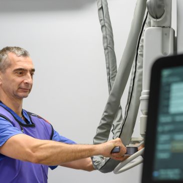 A radiologist operating the X-Ray