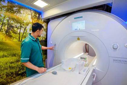 An MRI technician operates the MRI machine