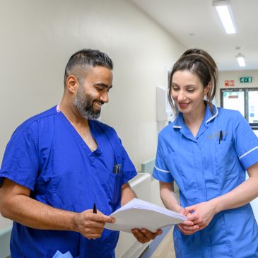 Nurses in discussion over a file