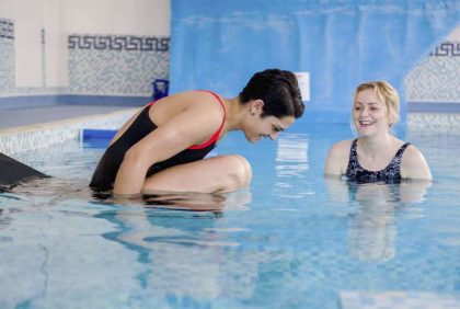 Entering hydrotherapy pool via slider