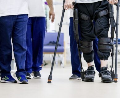 Patient using exoskeleton to assist leg movement