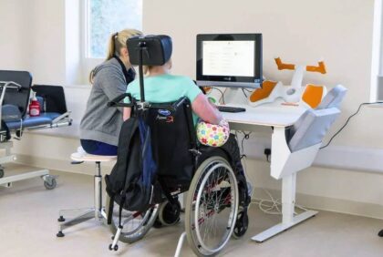 Wheelchair user at computer therapy console