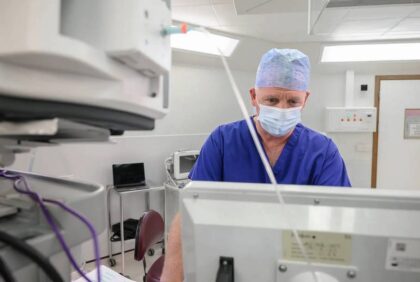 Surgeon inspecting monitor in theatre