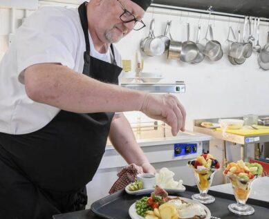 Chef preparing trayed meal in kitchen