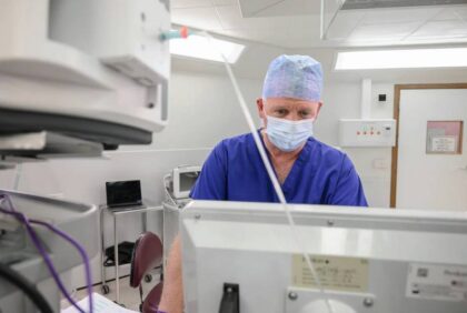 Consultant studying patient data on screen