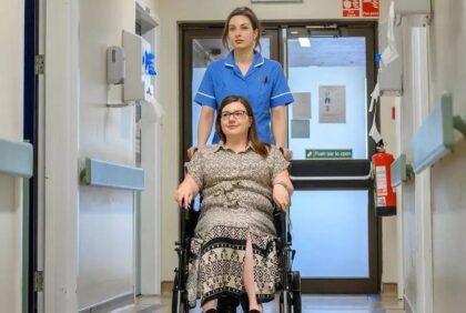 Nurse assisting patient in wheelchair