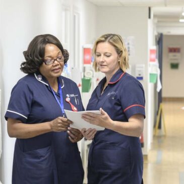 2 nurses examining report