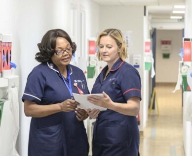 2 nurses examining report