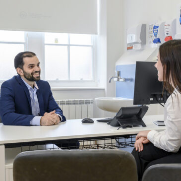 Private GP talking to patient in clinic