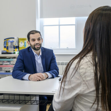 Private GP talking to patient in clinic