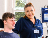 physiotherapist with spinal rehab patient